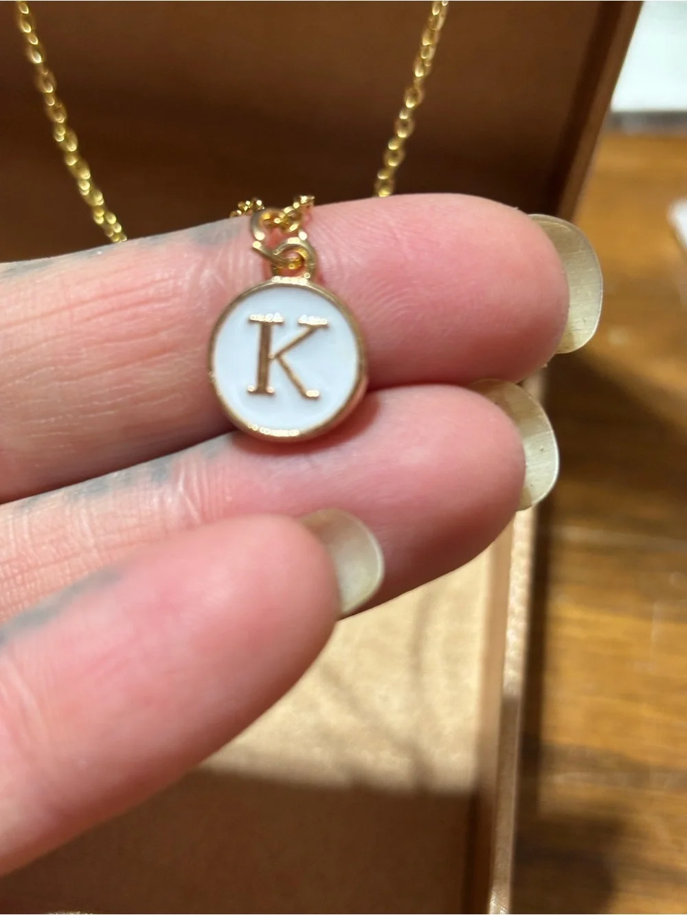 Gold tone initial K pendant necklace
